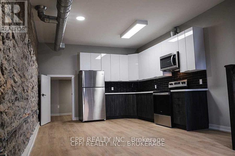 103 - 140 Simcoe Street, Peterborough (Town Ward 3), Ontario  K9H 0K5 - Photo 2 - X12664970